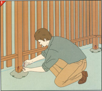 person placing string on a fence post as a marker